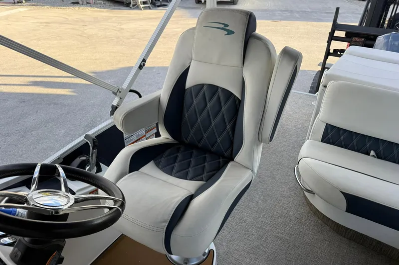 Slide: The Image of Captain's chair in 2019 Bennington R 25 RL pontoon boat, featuring luxury upholstery. - 16
