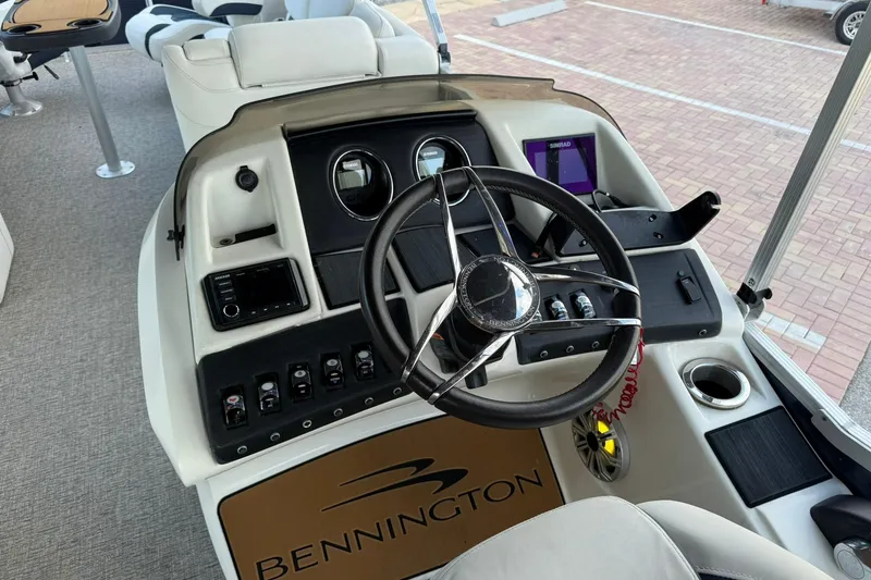Slide: The Image of 2019 Bennington R 25 RL boat dashboard with steering wheel and control panel. - 17