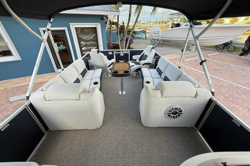 Slide: The Image of 2019 Bennington R 25 RL pontoon boat interior with plush seating and table. - 18