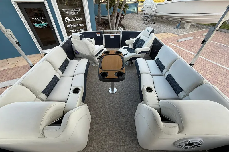 Slide: The Image of 2019 Bennington R 25 RL pontoon boat interior with plush seating and table. - 21