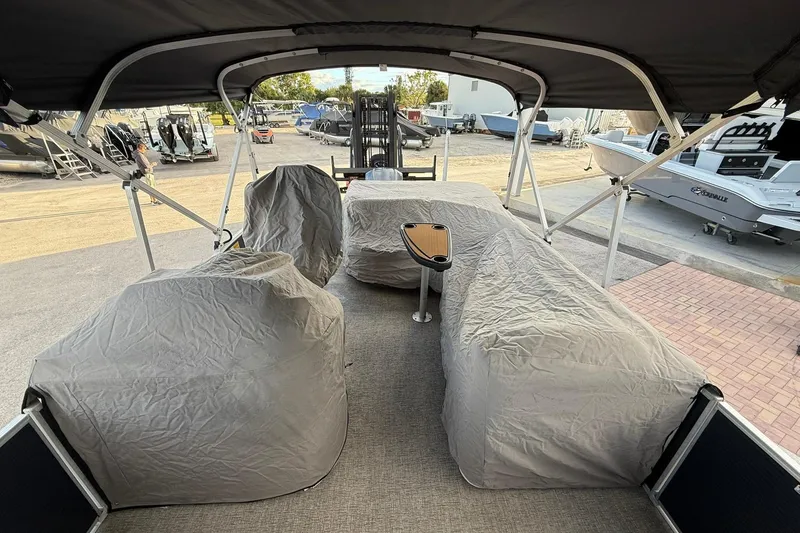 Slide: The Image of 2019 Bennington R 25 RL pontoon boat interior with covered seating and canopy. - 26