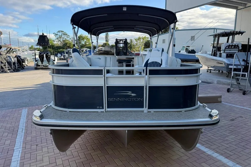 Slide: The Image of 2019 Bennington R 25 RL pontoon boat in a marina setting. - 3