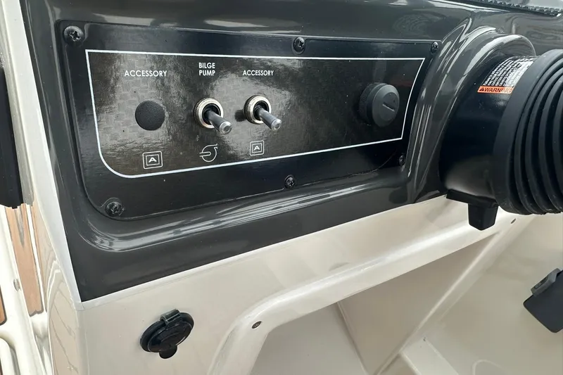 Slide: The Image of Control panel of 2026 Bayliner VR4 Bowrider OB with accessory switches and bilge pump. - 10