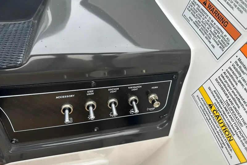 Slide: The Image of Control panel of 2026 Bayliner VR4 Bowrider OB with switches and warning labels. - 11