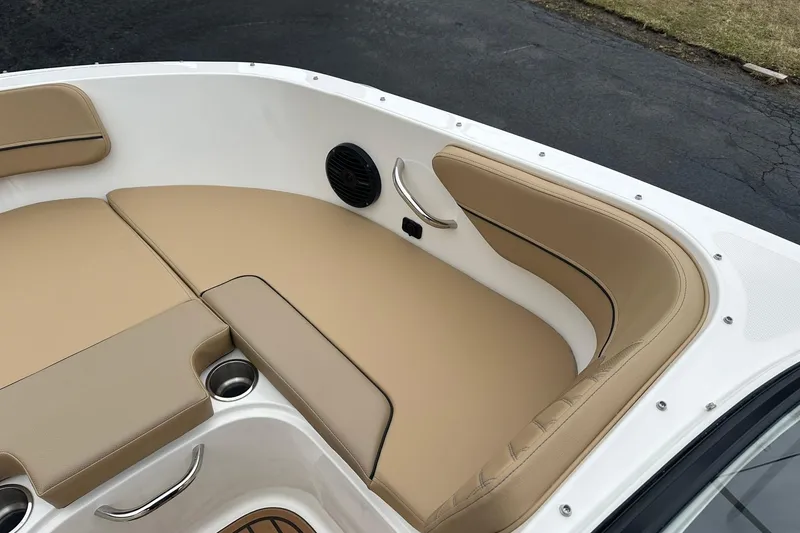 Slide: The Image of 2026 Bayliner VR4 Bowrider OB interior with tan seating and cup holders. - 14