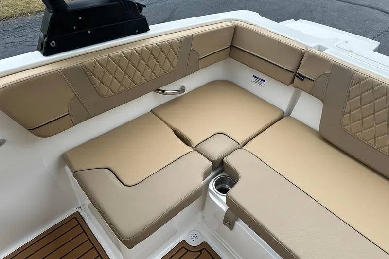 Slide: The Image of 2026 Bayliner VR4 Bowrider OB interior with tan cushioned seating and cup holder. - 18