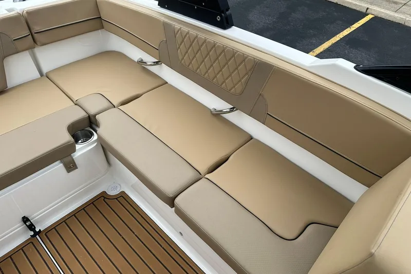Slide: The Image of 2026 Bayliner VR4 Bowrider OB interior with tan cushioned seating and cup holder. - 19