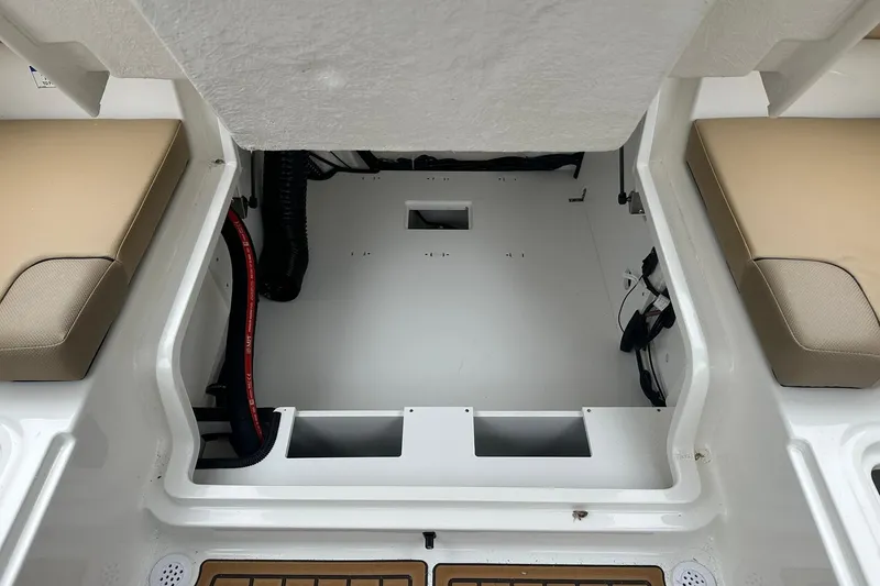 Slide: The Image of 2026 Bayliner VR4 Bowrider OB interior storage compartment with beige seating. - 20