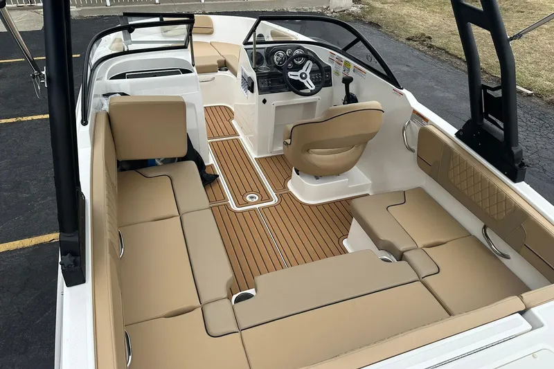 Slide: The Image of 2026 Bayliner VR4 Bowrider OB interior with tan seating and modern dashboard. - 5