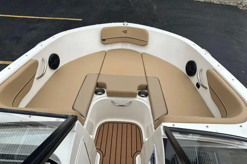 Slide: The Image of 2026 Bayliner VR4 Bowrider OB interior with tan seating and cup holders. - 6