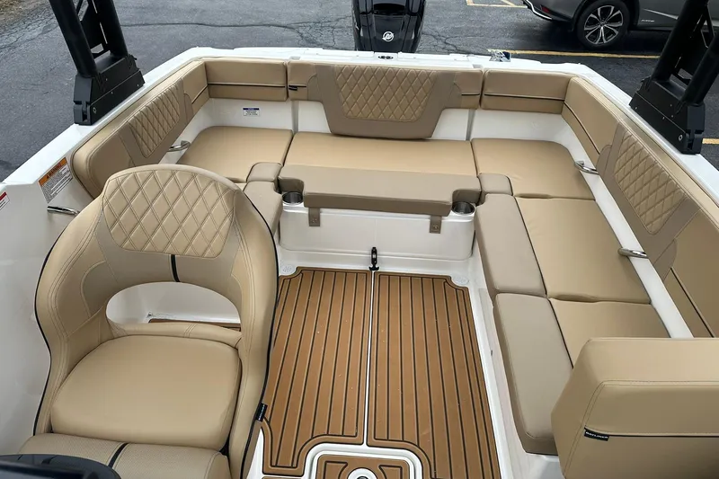 Slide: The Image of 2026 Bayliner VR4 Bowrider OB interior with tan seating and wood-style flooring. - 7