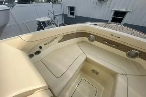 Slide: The Image of 2026 Chris-Craft Calypso 28 boat interior with seating, parked outdoors. - 12