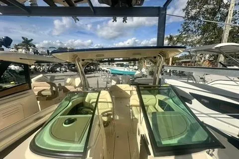 Slide: The Image of 2026 Chris-Craft Calypso 28 boat interior with seating and dashboard, parked outdoors. - 13