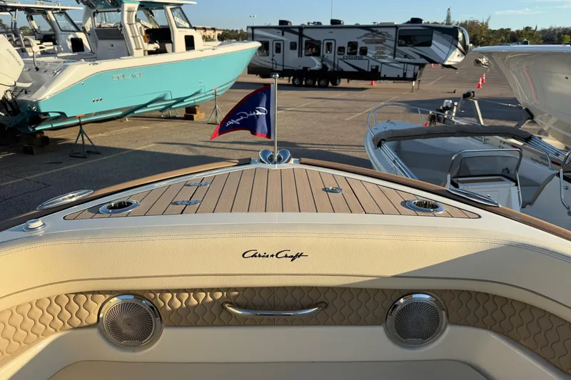 Slide: The Image of 2026 Chris-Craft Calypso 28 boat interior with elegant wood finish and marine flag. - 16