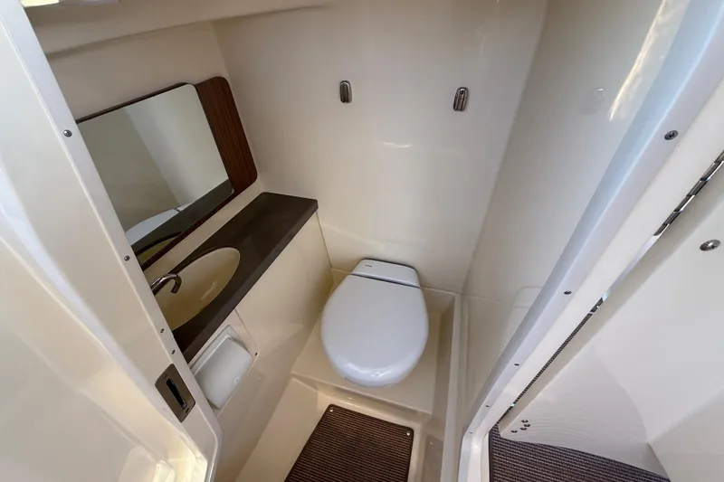 Slide: The Image of 2026 Chris-Craft Calypso 28 boat bathroom with sink, toilet, and mirror. - 19