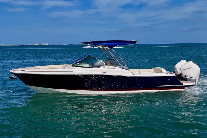 Slide: The Image of 2026 Chris-Craft Calypso 28 boat cruising on clear blue water under a sunny sky. - 21