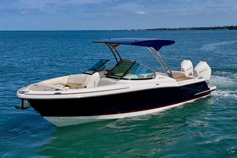 Slide: The Image of 2026 Chris-Craft Calypso 28 boat cruising on clear blue water. - 24