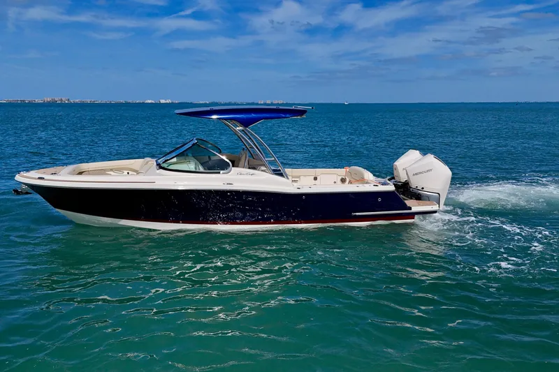 Slide: The Image of 2026 Chris-Craft Calypso 28 boat cruising on clear blue water under a sunny sky. - 25