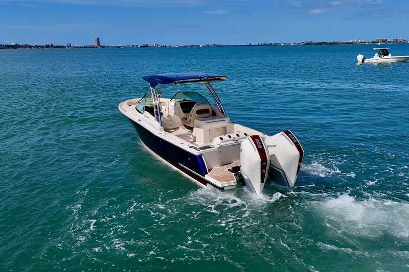 Slide: The Image of 2026 Chris-Craft Calypso 28 boat cruising on clear blue water. - 26