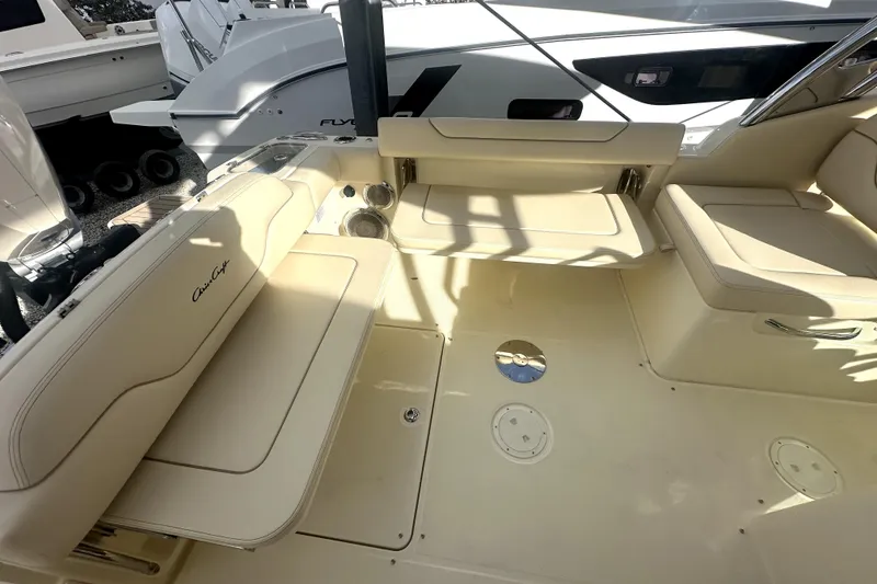 Slide: The Image of 2026 Chris-Craft Calypso 28 boat displayed outdoors on wooden blocks. - 7