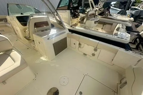 Slide: The Image of 2026 Chris-Craft Calypso 28 boat interior with seating and helm, displayed outdoors. - 8