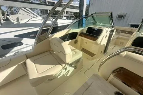 Slide: The Image of 2026 Chris-Craft Calypso 28 boat with beige seating and dual outboard motors. - 9