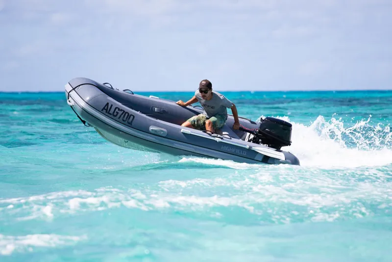 The Image of Manufacturer Provided Image: Man driving 2025 Highfield Classic 340 inflatable boat on turquoise ocean. - 0