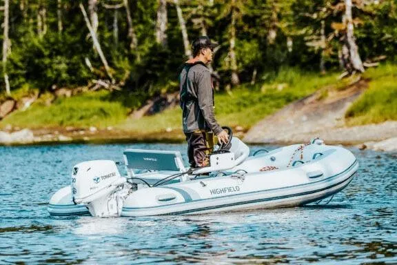 Slide: The Image of Manufacturer Provided Image: Man navigating 2025 Highfield Classic 340 boat on a serene lake. - 1