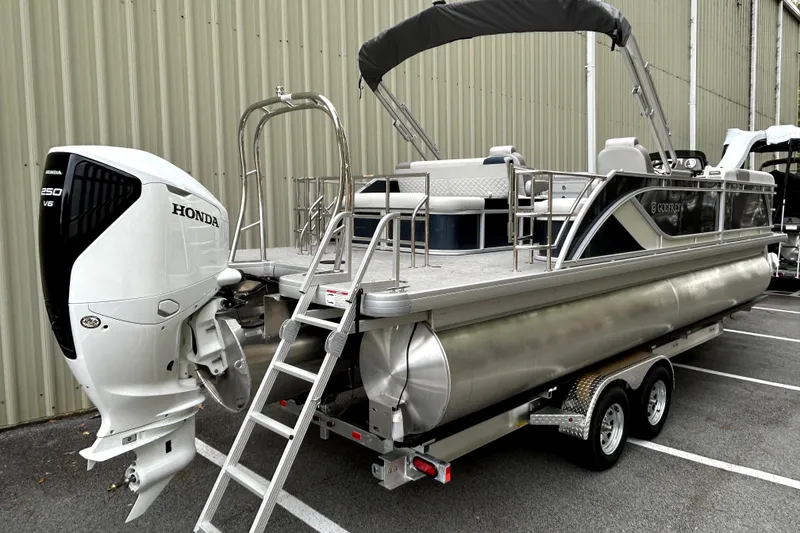 Slide: The Image of 2026 Godfrey Sweetwater 2286 SFLC pontoon boat with Honda 250 V6 engine, parked on trailer. - 2