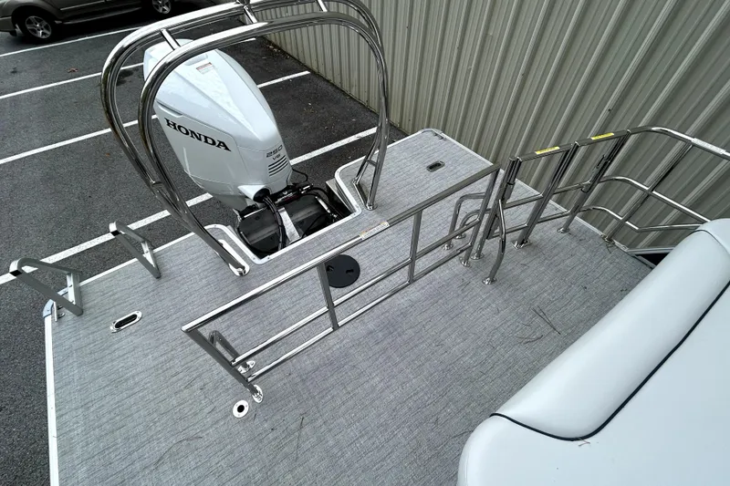 Slide: The Image of 2026 Godfrey Sweetwater 2286 SFLC boat with Honda engine, docked in parking lot. - 4