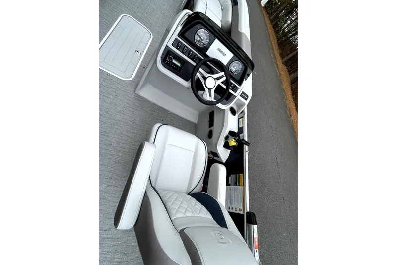 Slide: The Image of Interior of 2026 Godfrey Sweetwater 2286 SFLC boat with steering wheel and seating. - 7