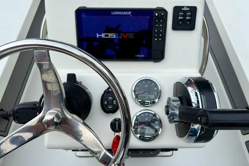 Slide: The Image of 2020 Beavertail Skiffs Vengeance dashboard with steering wheel, gauges, and Lowrance HDS Live display. - 14