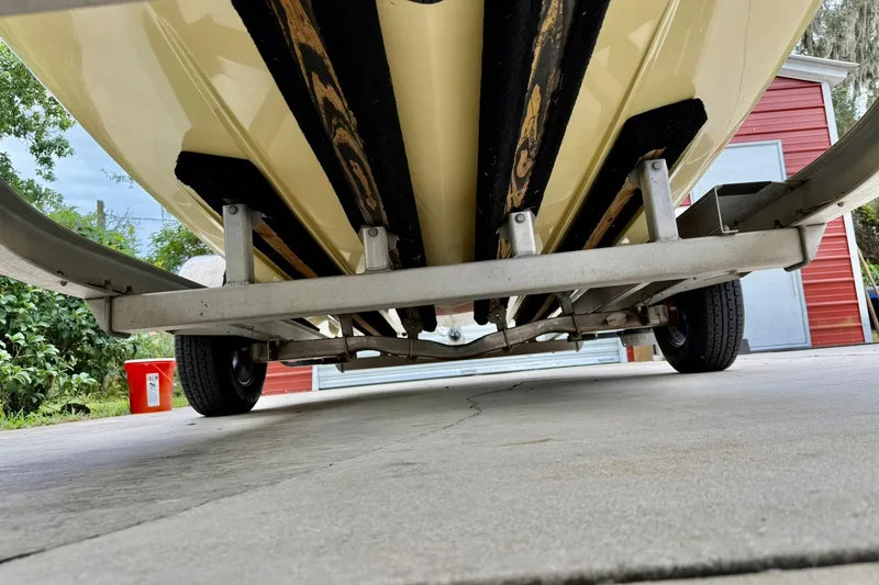 Slide: The Image of 2020 Beavertail Skiffs Vengeance boat on trailer, viewed from below, with red building background. - 4