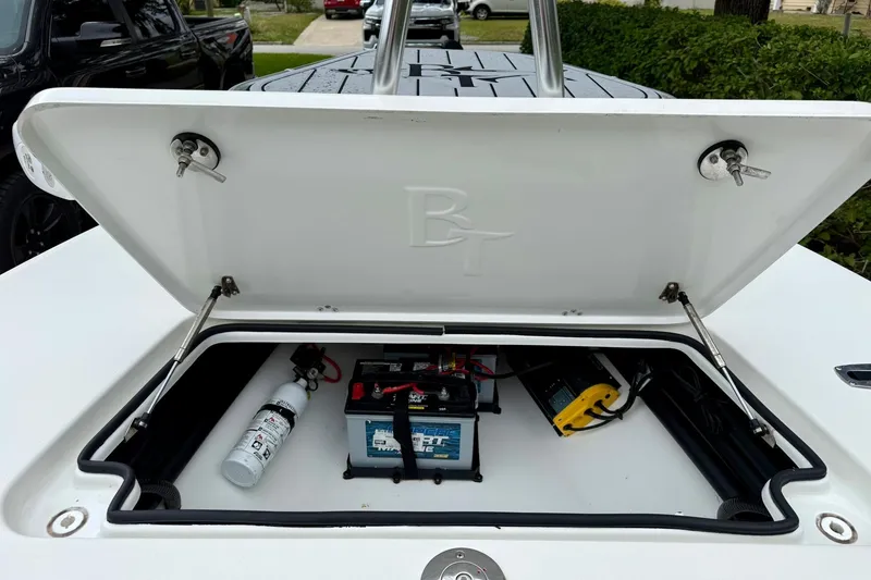 Slide: The Image of 2020 Beavertail Skiffs Vengeance storage compartment with battery and fire extinguisher. - 9