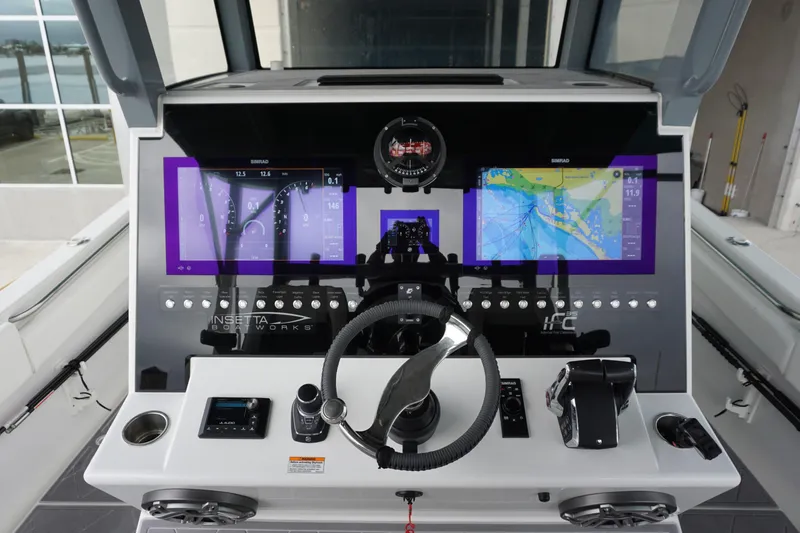 Slide: The Image of 2023 Insetta 35IFC boat dashboard with advanced navigation and control systems. - 16