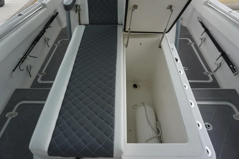 Slide: The Image of 2023 Insetta 35IFC boat interior with open storage compartment and cushioned seating. - 22