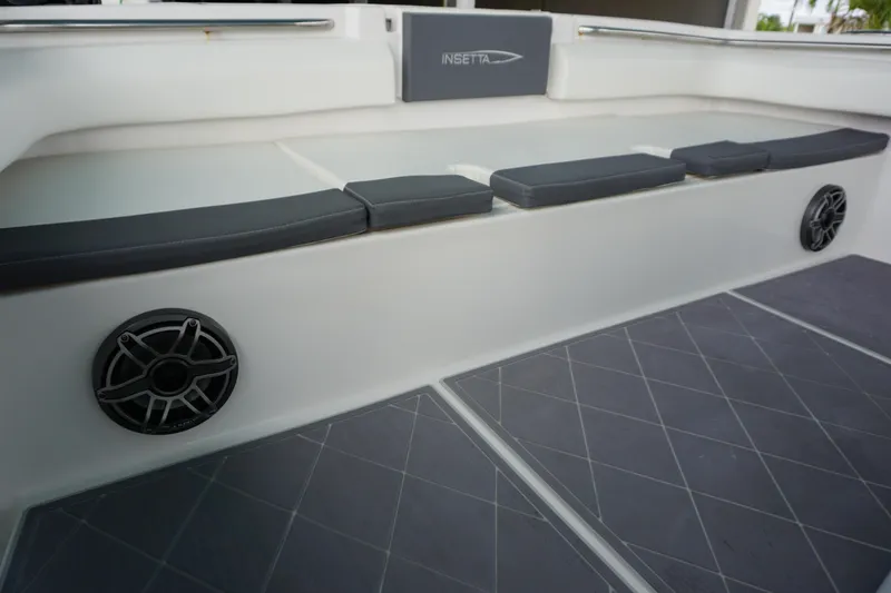 Slide: The Image of 2023 Insetta 35IFC boat interior with cushioned seating and built-in speakers. - 24