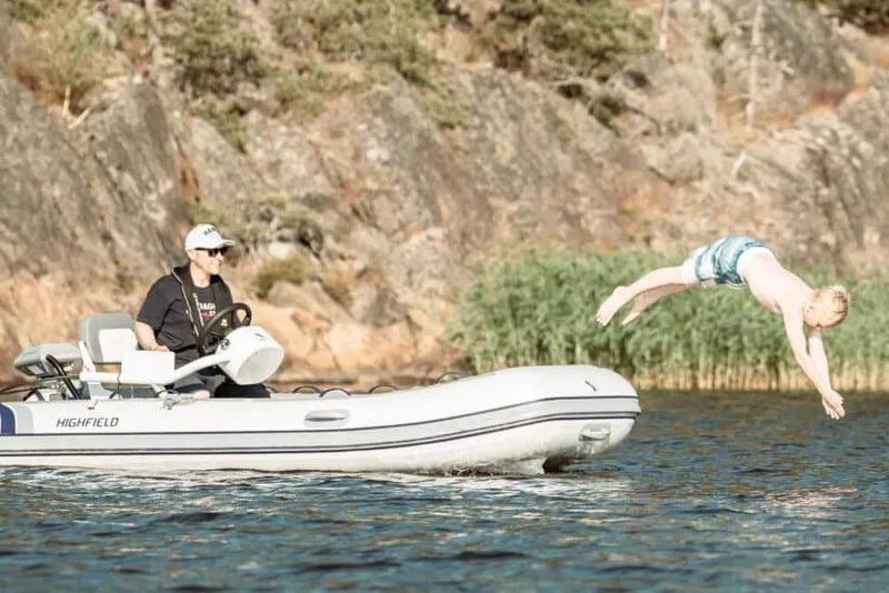 Slide: The Image of Manufacturer Provided Image: Man on 2025 Highfield Classic 380 boat, child diving into water. - 2