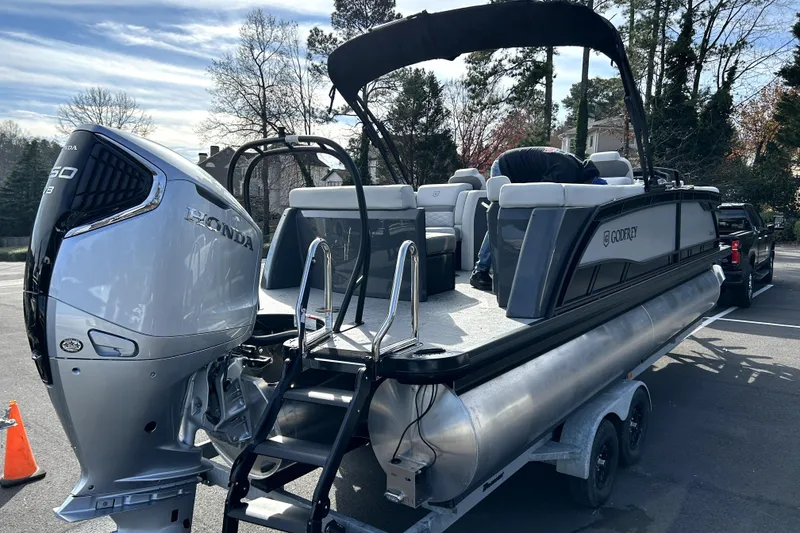 Slide: The Image of 2026 Godfrey Monaco 235 ULC pontoon boat with Honda engine on trailer. - 2