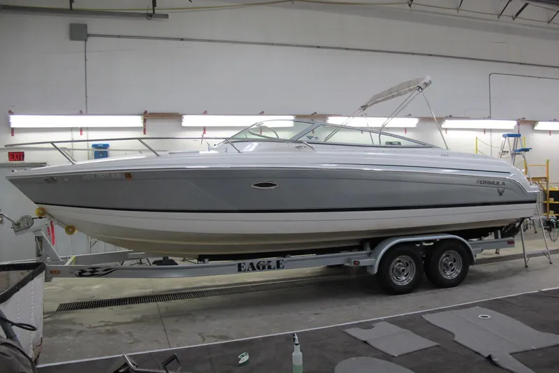 The Image of 2004 Formula 260 Sun Sport boat on trailer in indoor storage facility. - 0