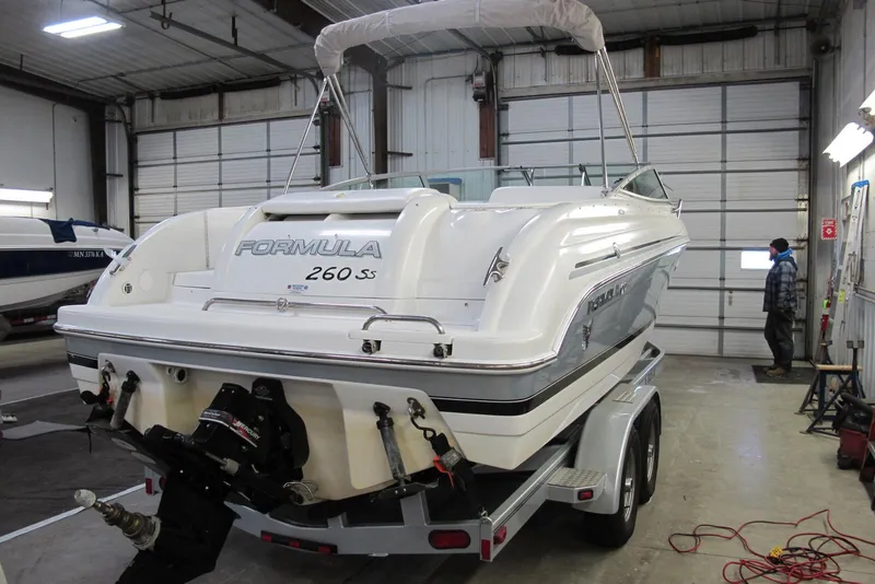 Slide: The Image of 2004 Formula 260 Sun Sport boat on trailer in indoor storage facility. - 2