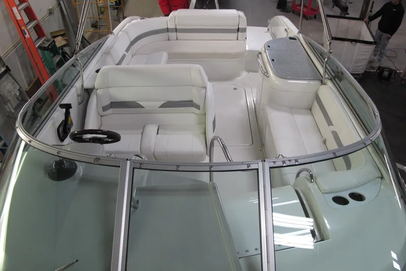 Slide: The Image of 2004 Formula 260 Sun Sport boat interior with white seating and steering wheel. - 5