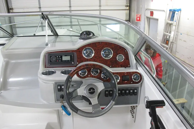 Slide: The Image of 2004 Formula 260 Sun Sport boat dashboard with steering wheel and gauges. - 6