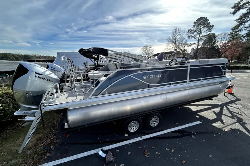 Slide: The Image of 2026 Godfrey Sweetwater 2286 SFL pontoon boat with Honda engine on trailer. - 1