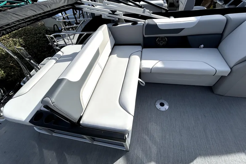Slide: The Image of 2026 Godfrey Sweetwater 2286 SFL boat interior with sleek white seating and cup holders. - 2