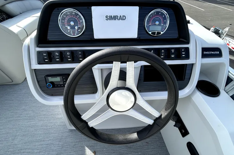 Slide: The Image of 2026 Godfrey Sweetwater 2286 SFL boat dashboard with steering wheel and control panel. - 4