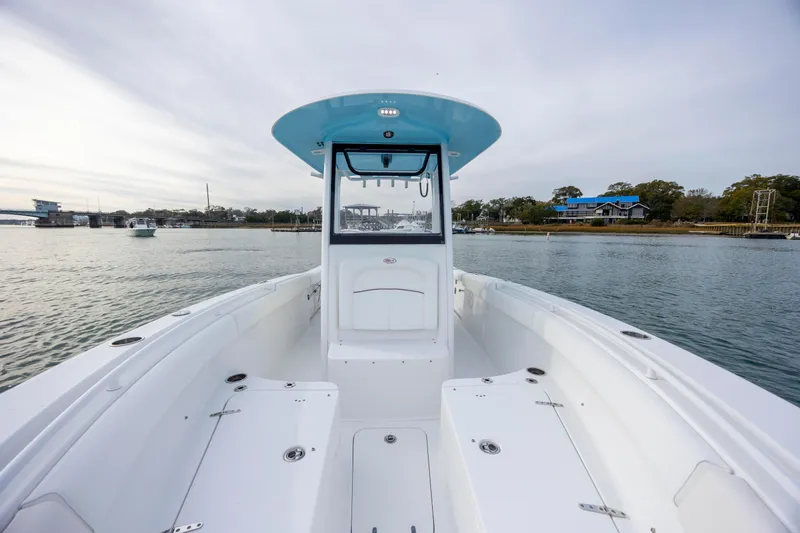 Slide: The Image of 2018 Sea Hunt Ultra 255 SE boat on calm water, scenic background. - 20