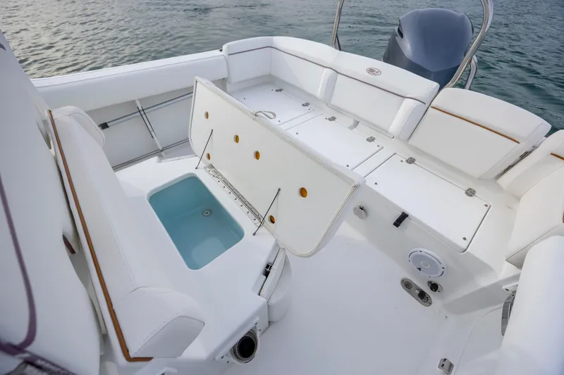 Slide: The Image of 2018 Sea Hunt Ultra 255 SE boat interior with seating and storage compartments. - 21