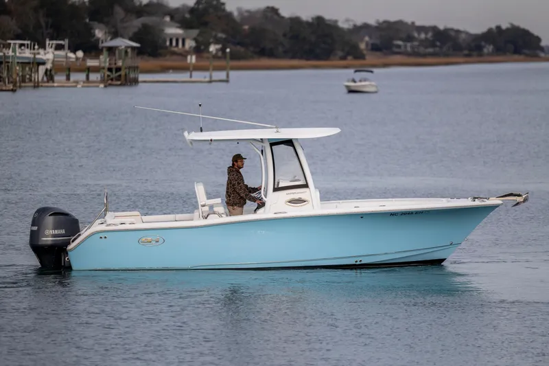 Slide: The Image of 2018 Sea Hunt Ultra 255 SE boat on calm water, featuring a Yamaha engine. - 6