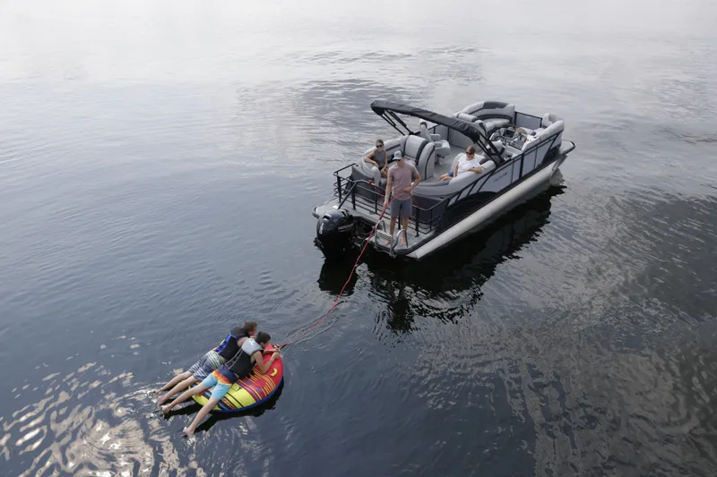 Slide: The Image of Sylvan L-3 ULZ 2026 pontoon boat with water sports activities on the lake. - 4